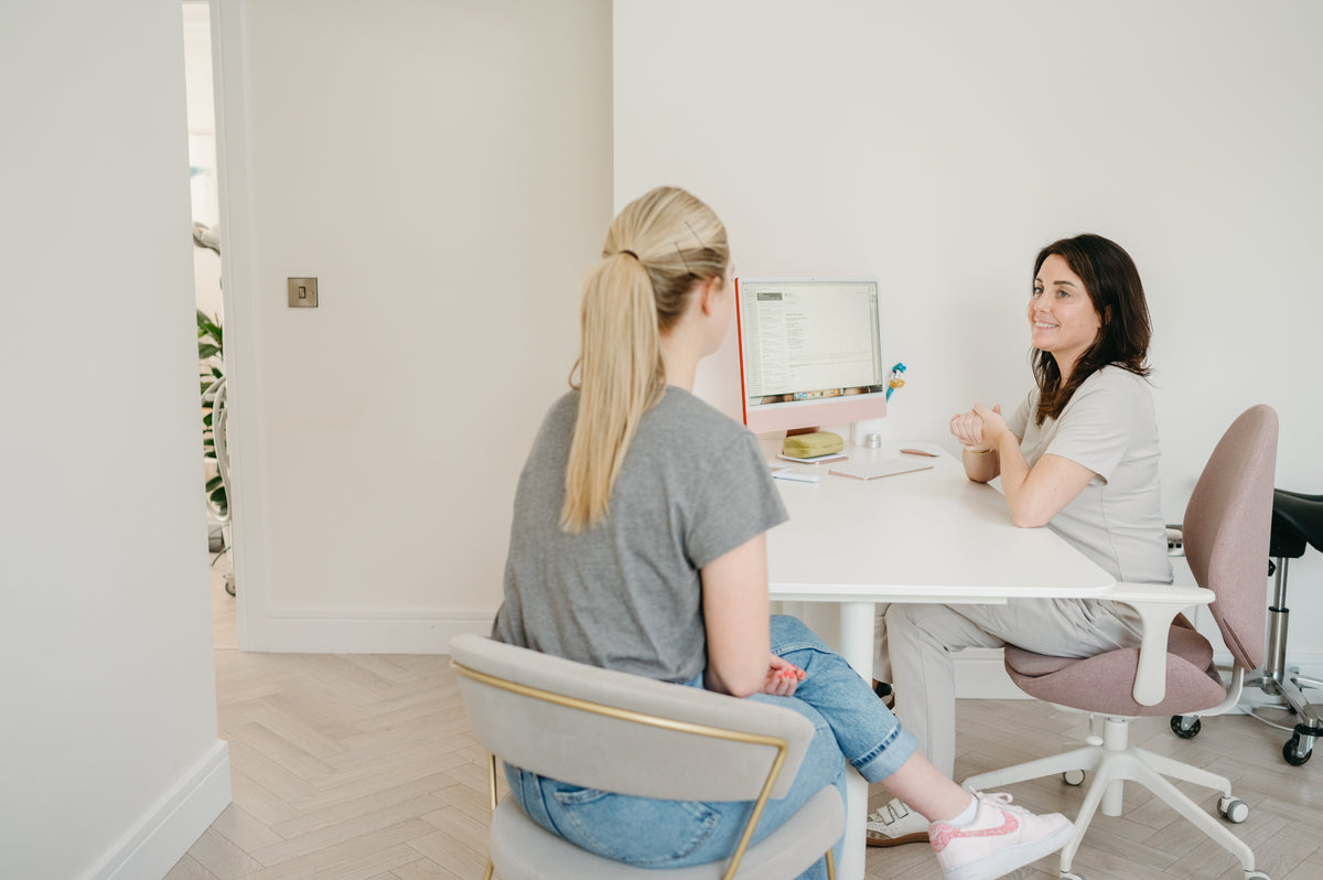 Dr Laura Lenihan consulting with a patient at Dr Laura Clinic